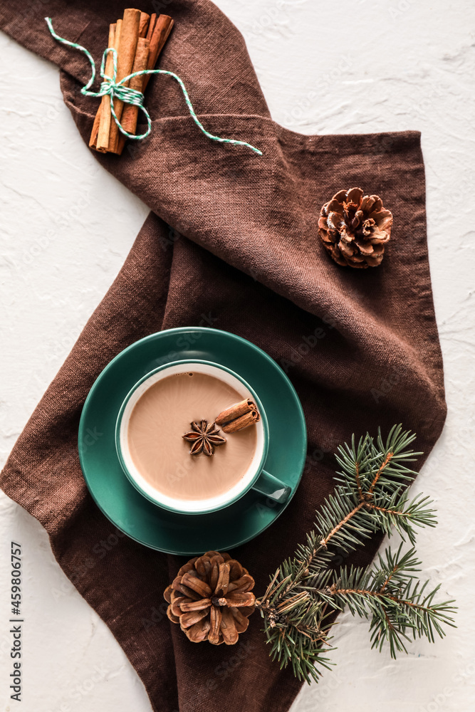 Composition with cup of hot cocoa drink and pine cones on light background