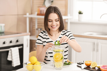 Sticker - Beautiful young woman making fresh lemonade at home