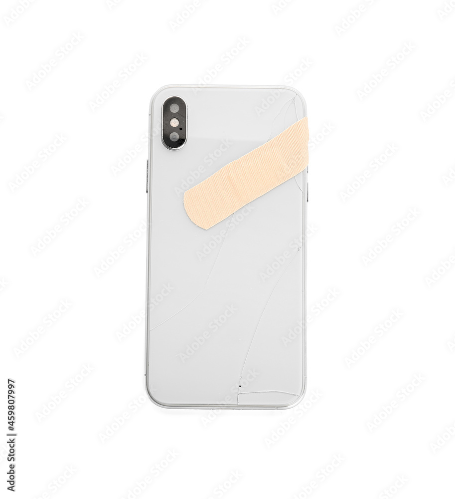 Broken mobile phone with medical plaster on white background