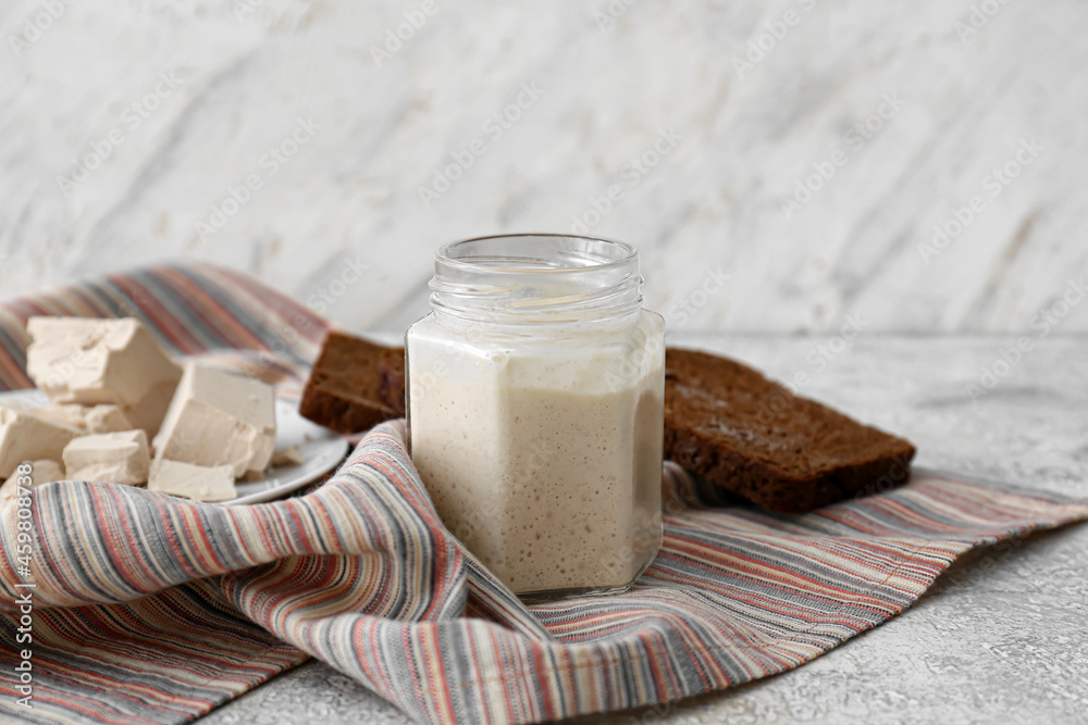 Jar with sourdough on table