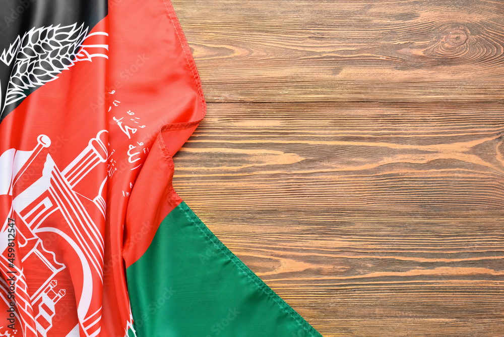 Flag of Afghanistan on wooden background