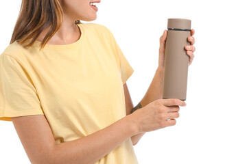 Wall Mural - Young woman with thermos on white background