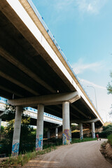 Poster - Vertical shot of a long bridge on a cloudy sky background