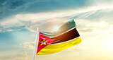 Fototapeta  - Mozambique national flag cloth fabric waving on the sky - Image