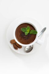 Wall Mural - cup with hot mint chocolate on white table, top view vertical