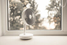 Modern Electric Portable Fan In Bedroom. Cooling Of High Air Temperature. Minimal Style, Copy Space.