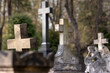 Old graves and crosses.  Sculpture of a sitting angel. Blurred background. Stone tombs.