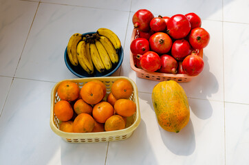 Wall Mural - Top view of fresh fruits, banana,pomegranate, orange