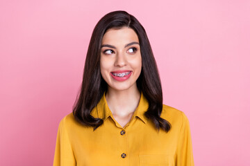 Wall Mural - Photo of funny brunette hairdo young lady look empty space wear yellow shirt isolated on pink color background