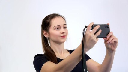 happy young caucasian woman taking selfie. isolated on white wall background. copy space. one smilin