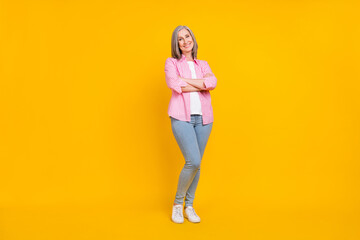 Full body photo of aged woman happy positive smile crossed hands confident isolated over yellow color background