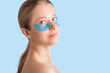 © Olesia - Cosmetology, skin care, face treatment, spa and self-care at home concept. Woman with eye gel pads mask.