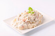 Ensaladilla rusa, potato salad with mayonnaise on white background 