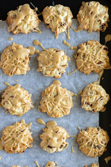 Wall Mural - A dozen homemade maple Vermont cookies on parchment paper, fresh out of the oven