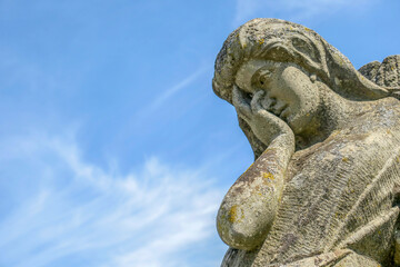 Wall Mural - A very sad angel in a stone in the cemetery