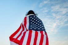 Rear View Of Woman With American Flag