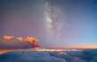 © ADDICTIVE STOCK - Milky way and volcano smoke over a sea of clouds