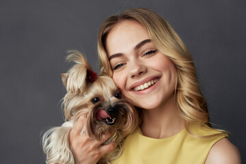 Wall Mural - beautiful woman with a small dog makeup posing cropped view fashion