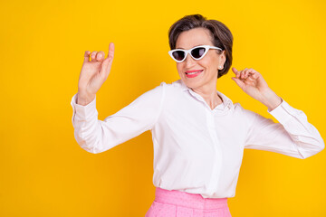 Poster - Photo of aged attractive woman happy positive smile have fun dance isolated over yellow color background