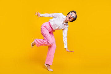 Wall Mural - Full body profile side photo of aged excited woman happy positive smile fooling playful isolated over yellow color background