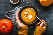 © somegirl - Female hands with bowl of pumpkin soup