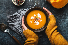 Female Hands With Bowl Of Pumpkin Soup