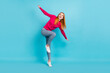 © deagreez - Full length body size view of attractive childish cheerful girl dancing having fun isolated over vivid blue color background