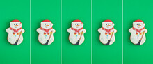 Christmas Collage. Christmas Gingerbread In The Shape Of A Snowman On The Green Background. Copy Space.