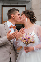 Groom hug and kiss bride in palm grove. Wedding day for two. Lovely weeding couple. Young lovers