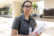 Portrait Of Civil Worker Carrying Books In Office Complex