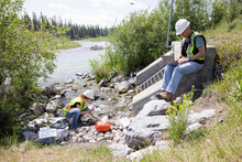 Environmental Inspectors Checking Water Quality Near Drain