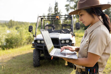 Ranger With Laptop In Front Of Off Road Vehicle
