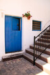Typical Andalusian whitewashed facade with blue wooden door