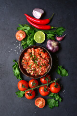 Wall Mural - Tomato salsa (salsa roja) - traditional mexican sauce  with ingredients for making .Top view with copy space.