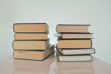 World Book Day.Reading and education concept. Library and reading room. Two stacks of books on a light background.Books close-up.