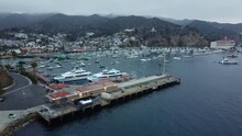 Wide Aerial Panning Shot Of Avalon Bay Passenger Ships, Harbor, And Casino, Santa Catalina