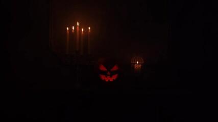 Wall Mural - Scary laughing pumpkin and old skull on ancient gothic fireplace. Halloween, witchcraft and magic.