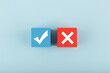 True and false symbol on blue and red cubes against bright pastel blue background. Concept of accept and reject, true or false, right or wrong