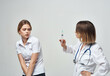 © SHOTPRIME STUDIO - female doctor syringe in hand treatment Studio hospital