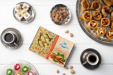 Wall Mural - Top view of Turkish sweets and Turkish coffee on white wooden background