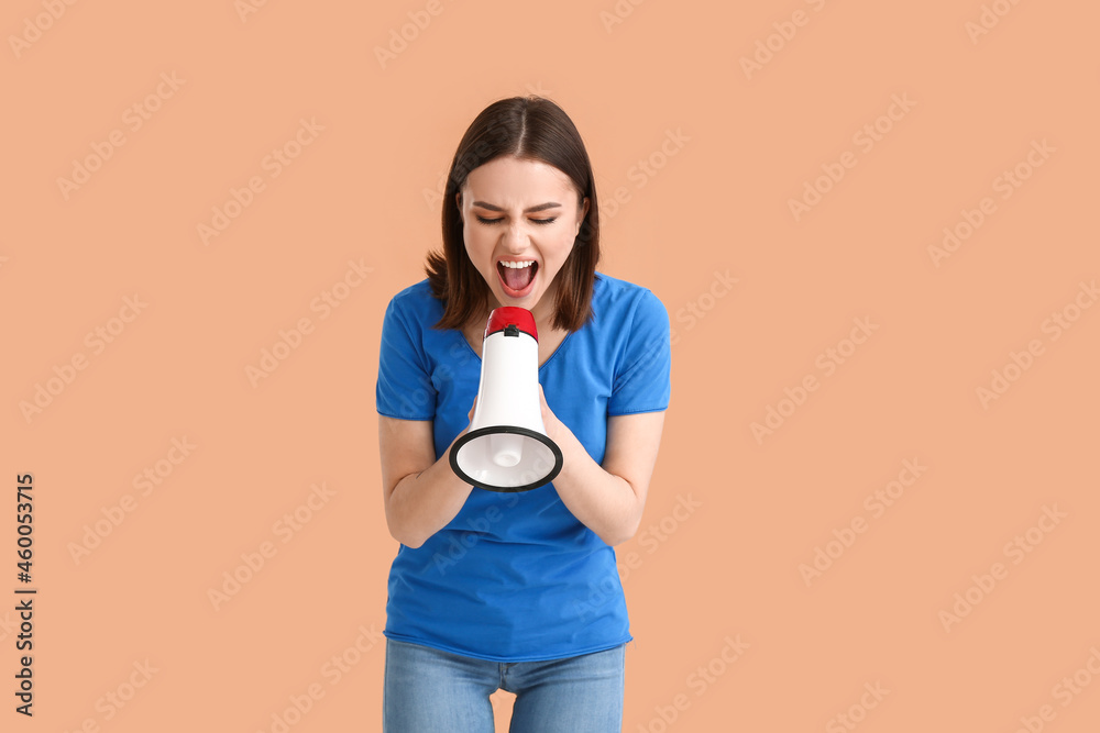 Protesting young woman with megaphone on color background