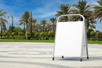 Poster - White Blank Advertising Promotion Stand as Template for Your Design in Empty City Street with Palm Trees. 3d Rendering