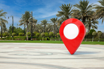 Fototapete - Red Map Pointer Pin in Empty City Street with Palm Trees. 3d Rendering