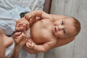 positive smiling baby looking at camera, above view