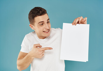 Wall Mural - man in white t-shirt white sheet copy-space advertising blue background