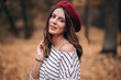 © Oleksandr - Portrait of brunette woman in autumn in the park. French style. Woman in beret and striped blouse