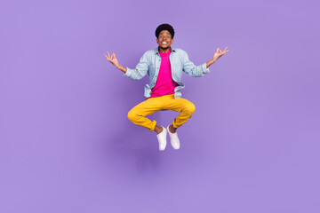 Wall Mural - Photo of calm sincere guy jump meditate lotus pose wear blue shirt pants shoes isolated purple color background
