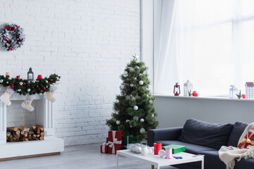 Canvas Print - spacious living room with christmas tree, decorated fireplace, sofa and table with christmas balls and bobbin of decorative ribbon