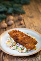 Wall Mural - Traditional Christmas dinner in Czech Republic - carp fillet with potato salad