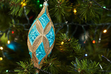 Christmas Toy In The Form Of A Blue Drop With Gold Sparkles. Christmas Decorations On The Christmas Tree